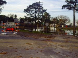 Barton and Megan Cutter drive through flooded waters.
